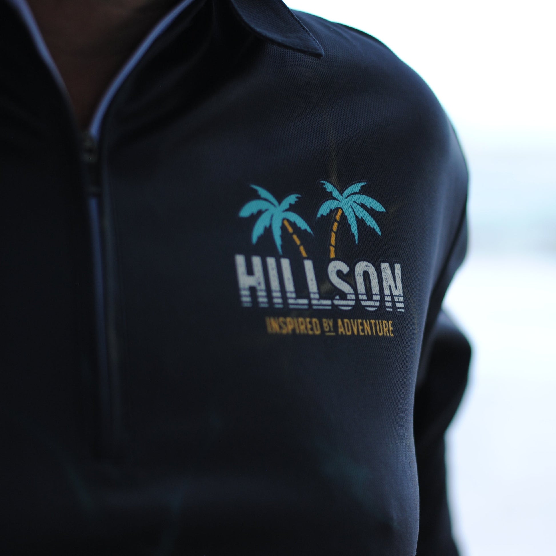 long sleeve fishing shirt with 'Hillson' logo featuring palm trees 